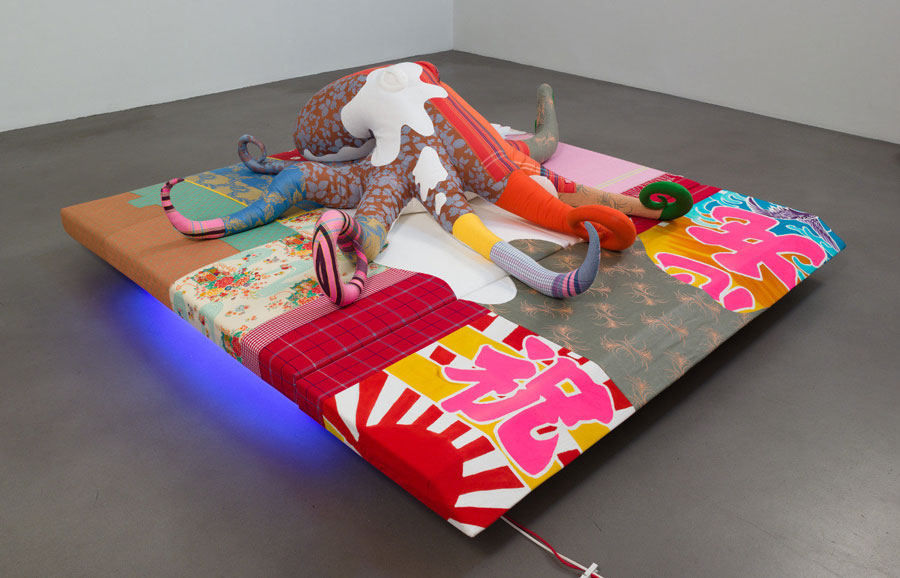 Cosima von Bonin (b. 1962 in Mombasa, Kenia. Lives in Cologne, Germany). Total Produce (Morality). 2010, base: various fabrics, foam materials, rubber, wood, neon tubes; octopus: various fabric, polyfill, octopus: 220 × 220 × 60 cm; pedestal: 25 × 230 × 250 cm. Courtesy Petzel Gallery